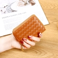 Brown woven leather card holder with gold zipper held in hand for size comparison - Tan