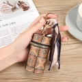 Cylindrical wood-patterned lipstick bag with gold keychain and elegant silk scarf detail - Vintage Brown (No.2)