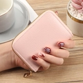 Pink PU leather card holder with litchi texture and gold zipper shown in a hand - Pink