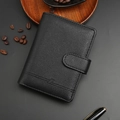 Black litchi grain leather passport holder wallet with debossed logo on wooden desk - Black