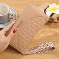 Beige quilted long wallet with a decorative geometric wrist strap and zipper closure - Khaki