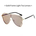 Oversized gold frame sunglasses with light tea lenses in a modern shield design - Gold Frame Light Tea Lens