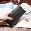 Elegant black lychee texture long wallet with flap closure on a rustic wooden table - Black