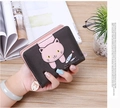 Close-up of pink cat patch and fish embroidery on brown leather wallet with bow charm - Black
