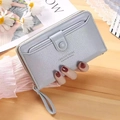 Long light blue wallet for women with wristlet strap and pebble leather texture - Light Blue