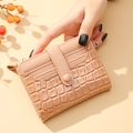 Beige faux leather wallet with crocodile texture and multi-card slots being held - Short Style / Pink