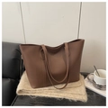 Brown large-capacity matte leather tote bag placed on beige plush fabric for daily commute - Brown