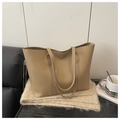 Detail of soft beige leather tote bag with reinforced stitching on high-quality plush rug - Khaki