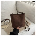 Detailed view of the dark brown suede bucket bag featuring a minimalist matte texture - Dark Brown