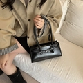 Chic black rectangular underarm bag with decorative metal buckle shown on a model - Black