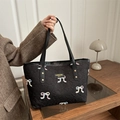 Quilted black tote bag with colorful embroidered bows and slender shoulder straps - Black