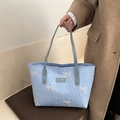 Light blue tote bag with embroidered bow accents and quilted diamond pattern - Blue