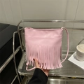 Pink bohemian crossbody bag featuring long tassels and a minimalist faux leather design - Pink