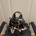 Dark brown patent leather underarm bag with metal chains and gothic bow charms - Brown