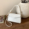 Detail of white textured fabric handbag with unique knotted rope handle and gold buckle - White