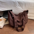 Large brown canvas hobo tote bag with wide strap in a minimalist lifestyle setting - Brown