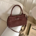 Detail of dark brown suede bucket bag with silver buckle on a textured sofa background - No Pendant / Brown