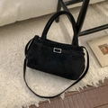 Detail of black suede bucket bag with silver buckle on a plush white rug background - No Pendant / Black