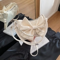 Elegant off-white crossbody bag with bow design and decorative pearl flower chain - White