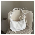 Detail of white crescent bag with wrinkled texture and decorative side ribbons - White