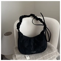 Detail of black pleated croissant bag with bow ribbon and fashion text on soft fabric - Black
