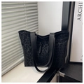 Detail of minimalist black leopard print canvas tote bag with wide shoulder straps - Black