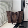 Close-up of leopard print tote bag with woven drawstring detail and nylon strap - Coffee