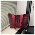 Detail of burgundy leopard print canvas tote bag with vibrant red webbing handles - Red