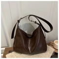 Detail of vintage dark brown hobo bag with glossy leather finish and silver metal buckle - Brown