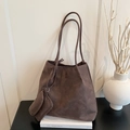Large capacity dark brown tote bag with small square pouch on minimalist white books - Brown