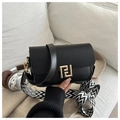 Detail of matte black crossbody square bag with gold geometric lock and patterned strap - Black