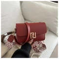 Detail of red crossbody bag with golden geometric buckle and patterned woven strap - Red