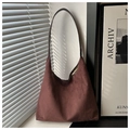 Detail of dark brown suede tote bag featuring slim leather straps and matte finish - Coffee