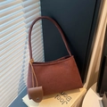 Minimalist burgundy suede underarm tote bag with a small leather charm detail - Brown