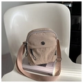 Detail of khaki nylon pleated crossbody bag with silver logo and adjustable strap - Khaki