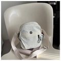 Detail of a cream nylon crossbody bag featuring textured fabric and a metal logo badge - White