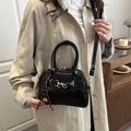 Retro black shell crossbody bag with gold horsebit hardware and brown tassel - Black