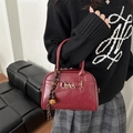 Retro deep red shell bag with gold horsebit buckle and decorative woven charm - Red