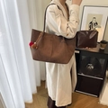 Retro matte brown large tote bag with inner pouch and pom-poms on a beige trench coat - With Pendant / Coffee