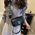 Fashionable black leather crossbody bag with wide patterned strap and gold square buckle - Black