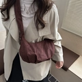Brown suede crossbody dumpling bag with wide strap and minimalist half-moon shape - Coffee
