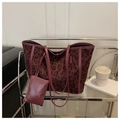 Detail of burgundy leopard print tote bag with matching zippered pouch and leather handles - Red