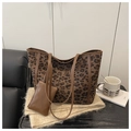 Detail view of leopard print tote bag with matching mini pouch and brown faux leather straps - Brown