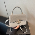 Grijze lederen crossbodytas met luipaardprint suède flap en metalen draaisluiting op de tas - Grijs