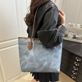 Washed blue cloud-pattern tote bag with brown leather handles worn by a model - Blue (Without Charm)