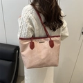 Stylish pink large tote bag with red trim shown on shoulder of model in white sweater - Pink (No Charm)