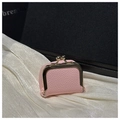 Detailed view of pink pebble grain leather mini clasp purse on white silk fabric - Pink