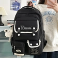 Black high-capacity nylon backpack with white contrast trim and plush bear keychain - With Charm / Black