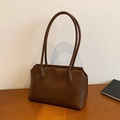Minimalist brown vegan leather tote bag with long straps on a wooden table setup - Brown