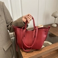 Deep red bucket bag with lychee pattern leather and stylish white contrast stitching - Red